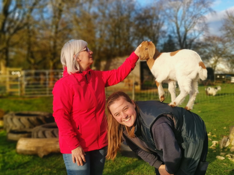 Susan Broccoli from We Love Peterborough fussing a baby goat at Sacrewell Farm