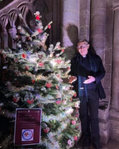The Dean of Peterborough Cathedral admiring the Christmas Tree festival